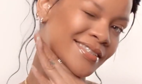 Rihanna winking in a new Fenty Beauty "Fenty Face" ad